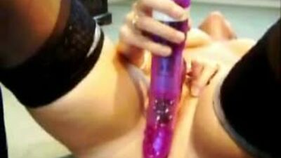 Playing with a purple dildo