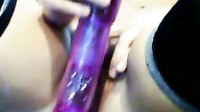 Playing with a purple dildo