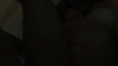 Woman masturbates with a dildo in the bedroom