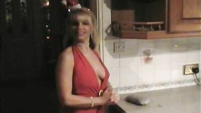 Lynda in hot red dress teasing the camerman with her boobs