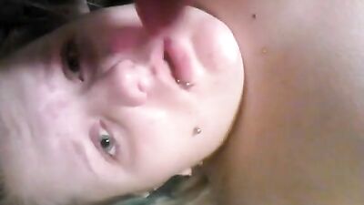 A woman uses a dildo with a cock ring on the bed