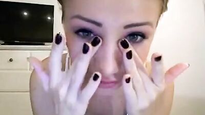 Babe in a white tank top plays with her tits in front of the camera.