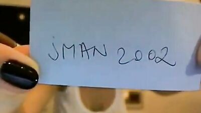 Babe in a white tank top plays with her tits in front of the camera.