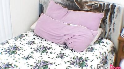 Sunshine fucks herself with a dildo on the bed