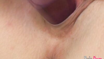 Sexy Bri fucks her pussy with a big purple dildo on the bed