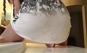 Shaking her ass on a dildo