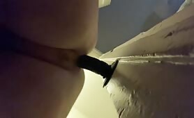 Taking a wall dildo in her fat pussy 